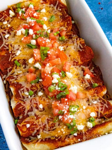 Cheese enchiladas with chopped tomato and green onion - easy, melty, and loaded with bold flavor.